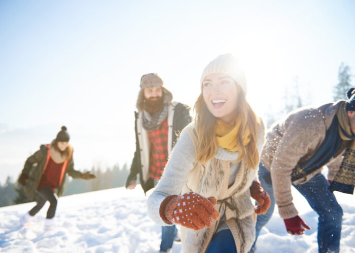 Family playing and laughing in the snow