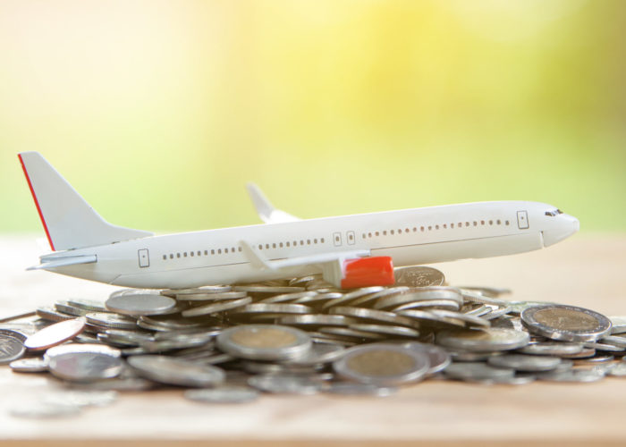 Model plane on pile of coins