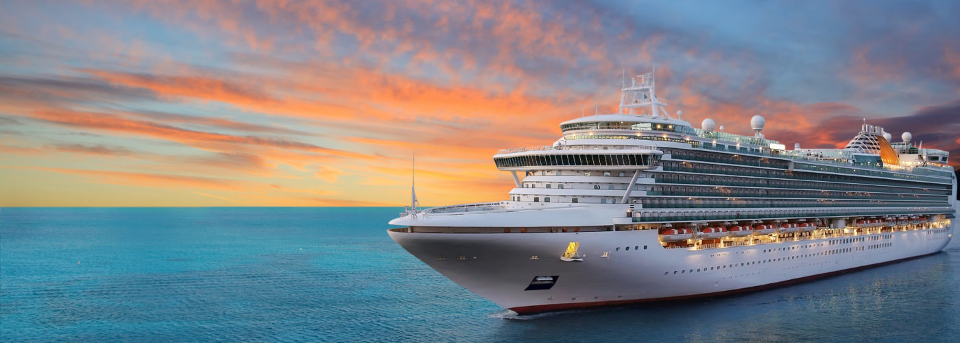 Cruise ship sailing at sunset