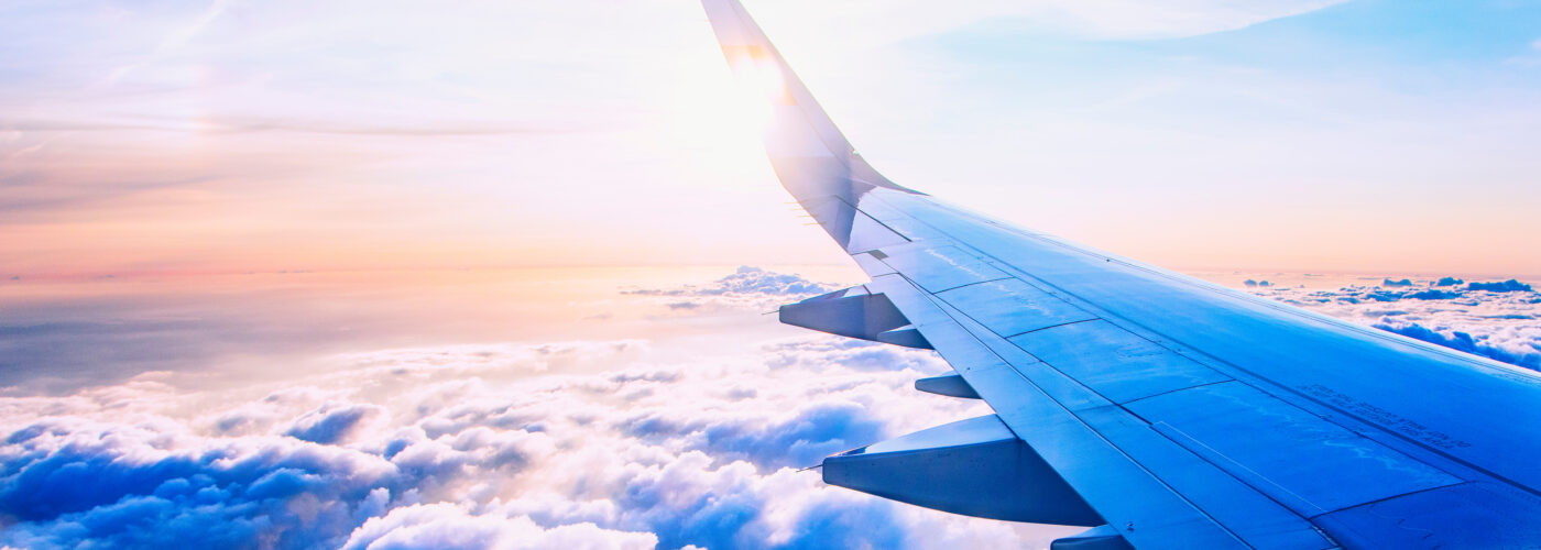 Airplane wing as seen from airplane window mid-flight