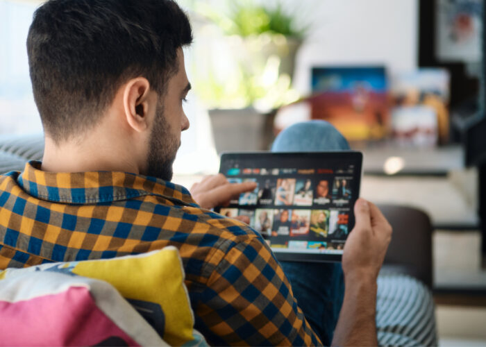 Person streaming television to an iPad while sitting on the couch