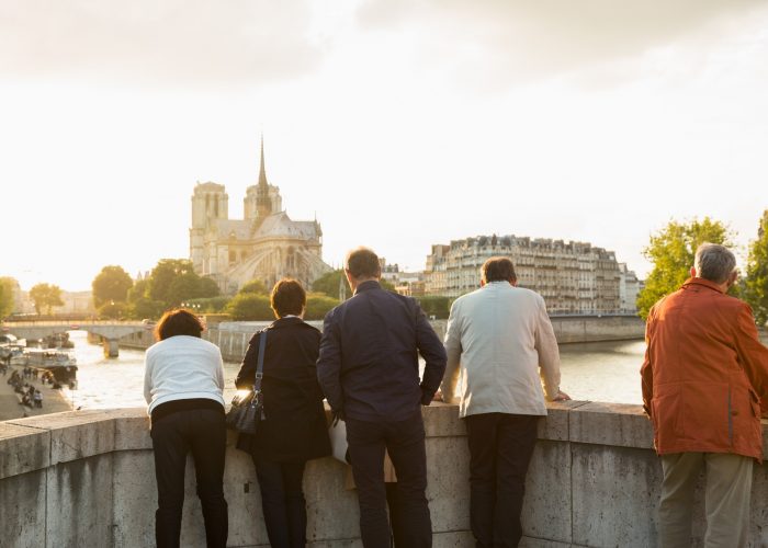 france-paris-friends-tourists-traveling-seniors-retired-notre-dame-retirement-tour-group