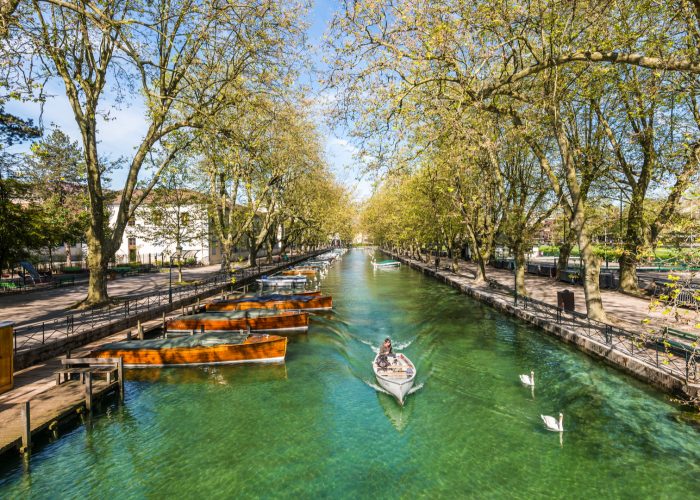 woman paddling boat on canal in france.